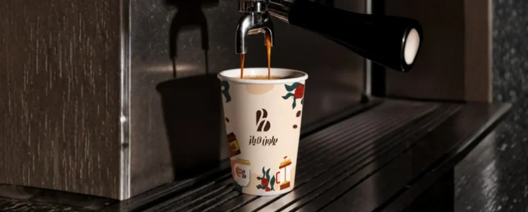 Coffee cup with custom branded packaging design showcasing visual identity